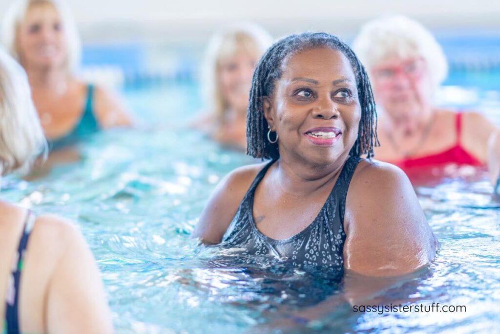 five middle aged and older woman taking an aqua exercise class.