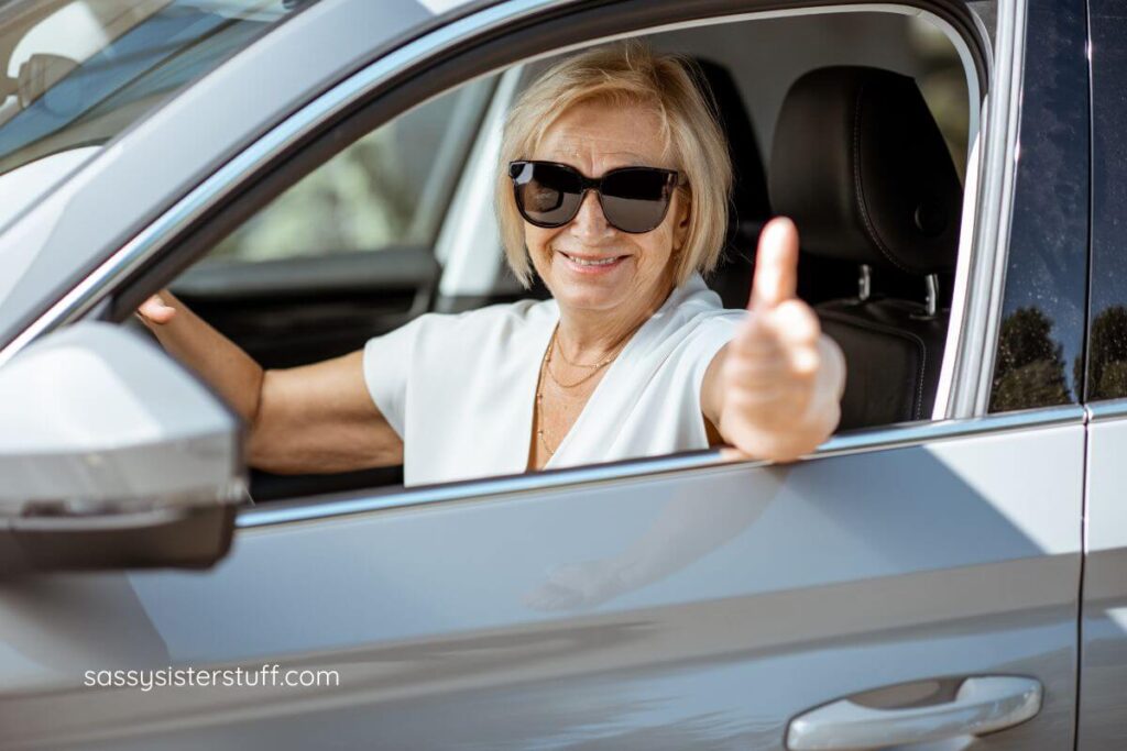 a woman gives a thumbs up after buying her new vehicle.