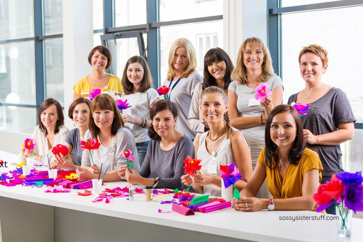 a large group of women enjoy time doing crafts together.