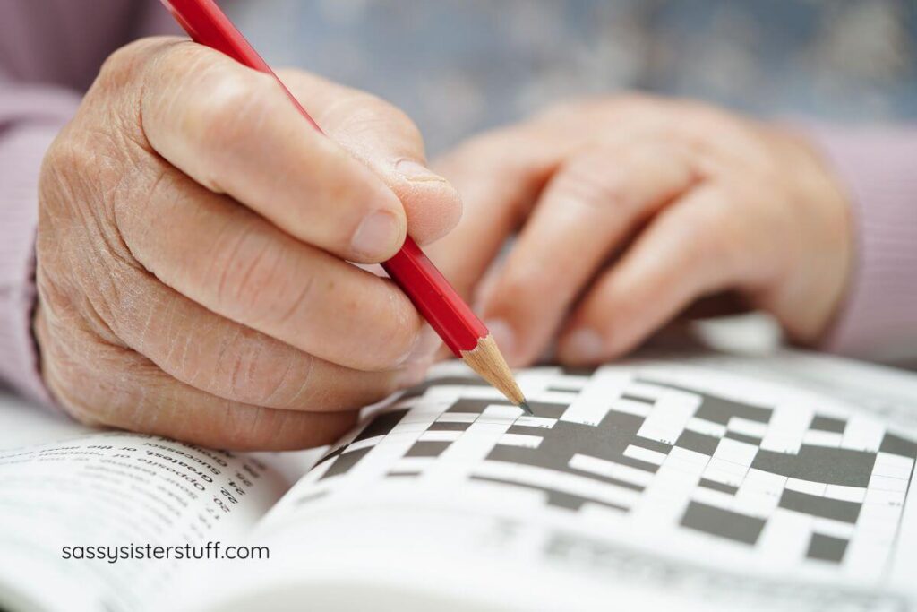 close up of someone doing a crossword puzzle.