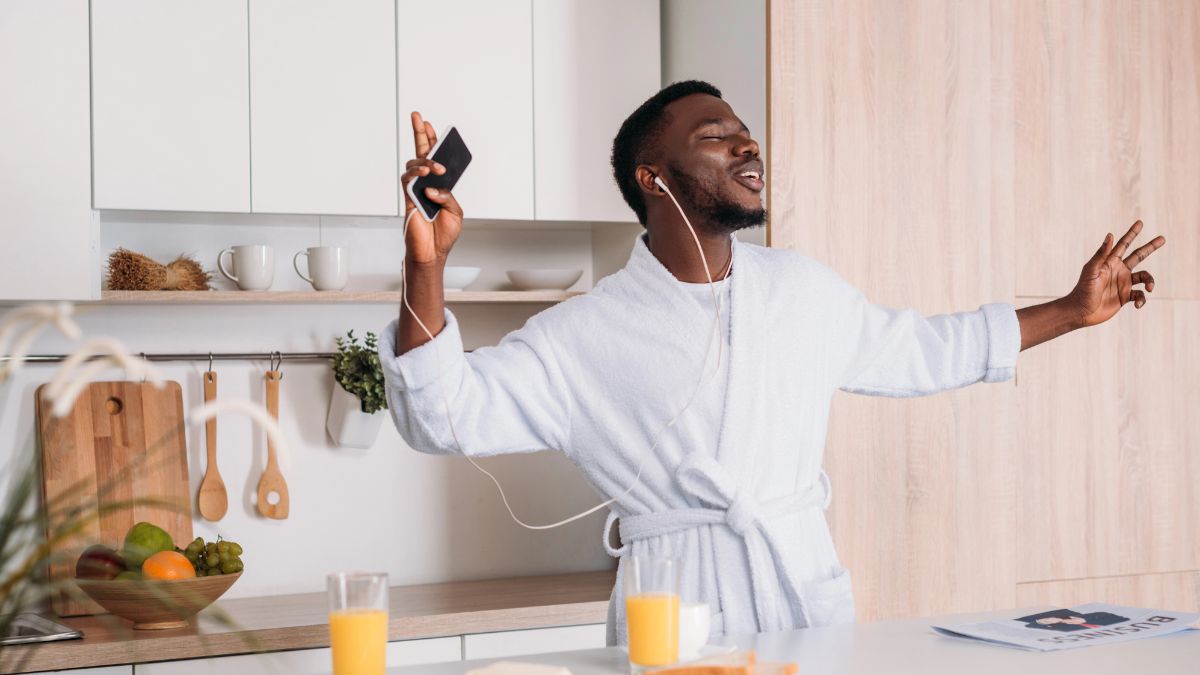 man dancing in kitchen with breakfast