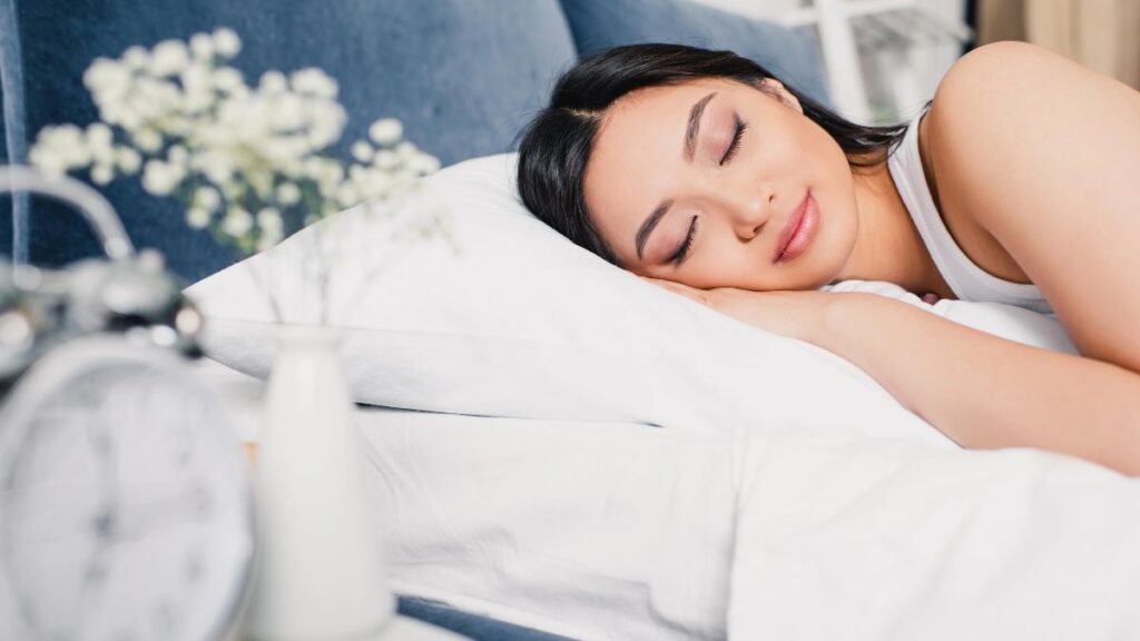 woman sleeping on blue bed