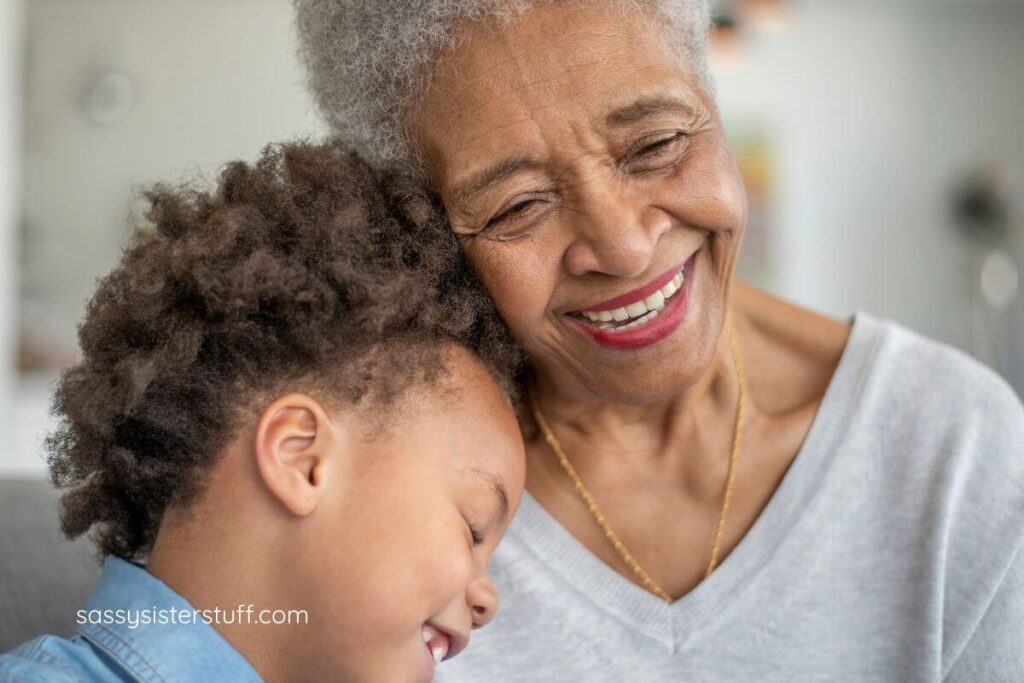 close up of happy grandmother and young granddaughter hugging and smiling.