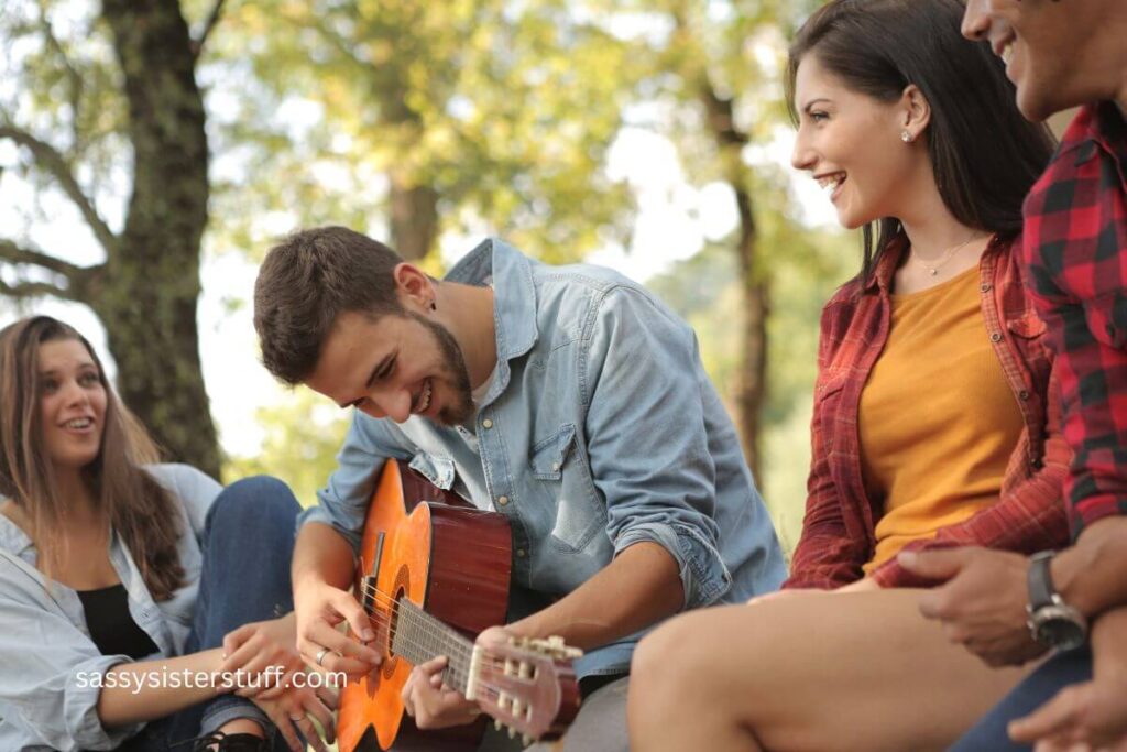 group of friends spending time in nature singing together.