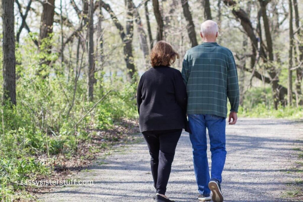 middle aged couple taking a walk through the woods.