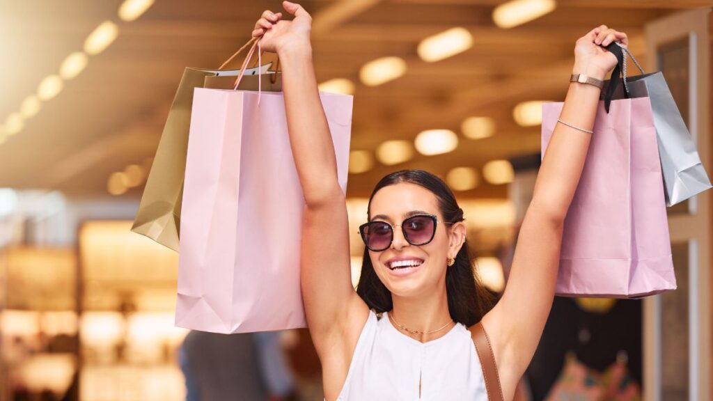 excited woman with shopping bags