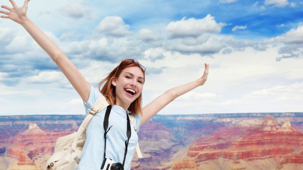 happy woman traveling at grand canyon