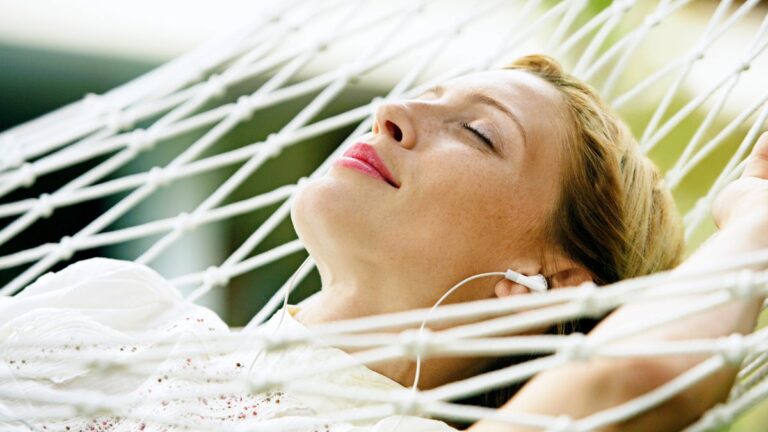 woman listening on hammock