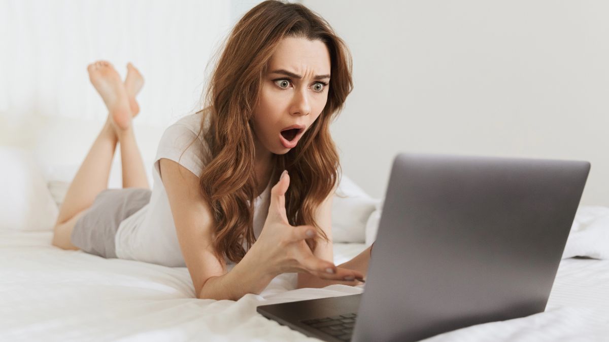 woman on computer looking surprised