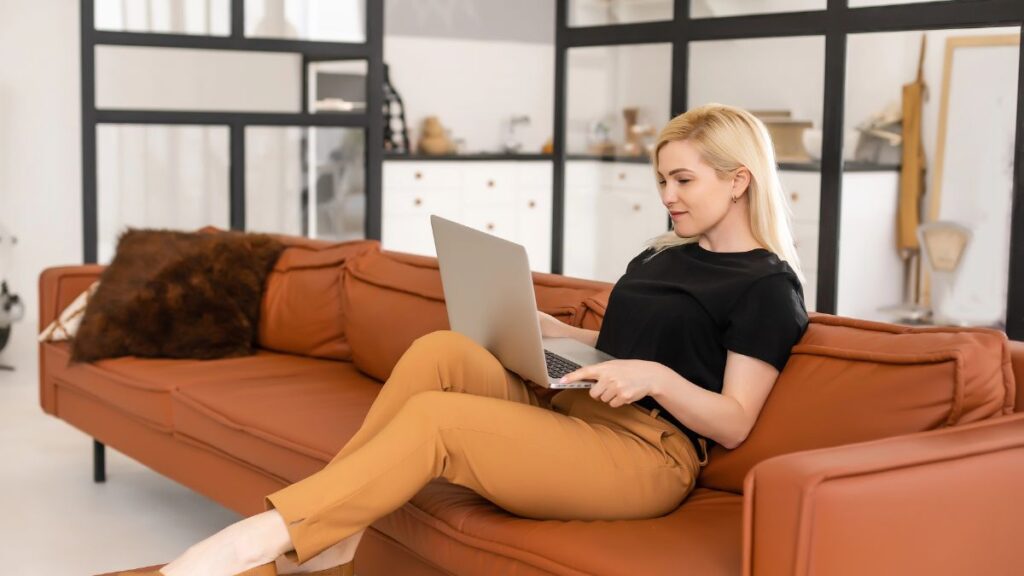 woman on couch with computer