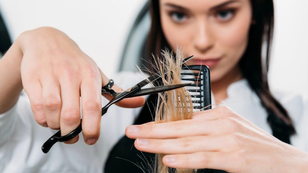 woman trimming hair 