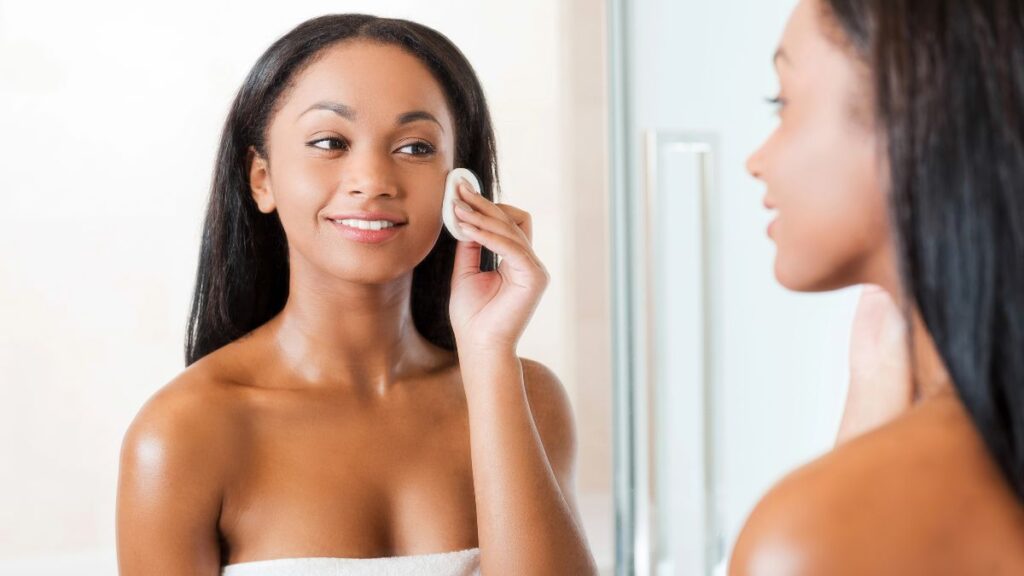 woman washing face in mirror