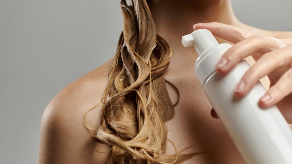 woman washing hair with conditioner