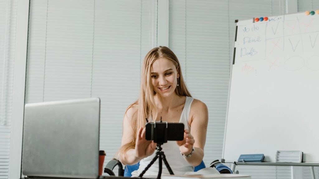 woman with phone and computer