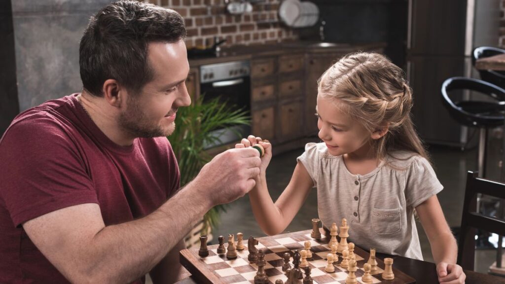 dad and daughter playing chess