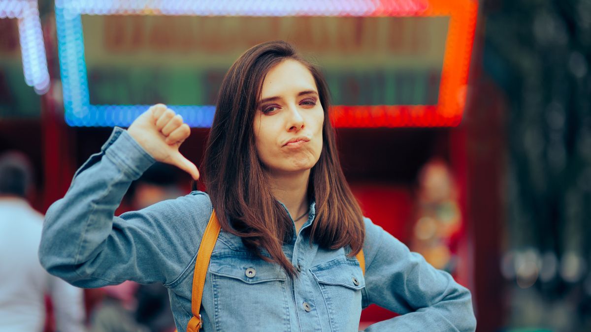frustrated woman showing thumbs down